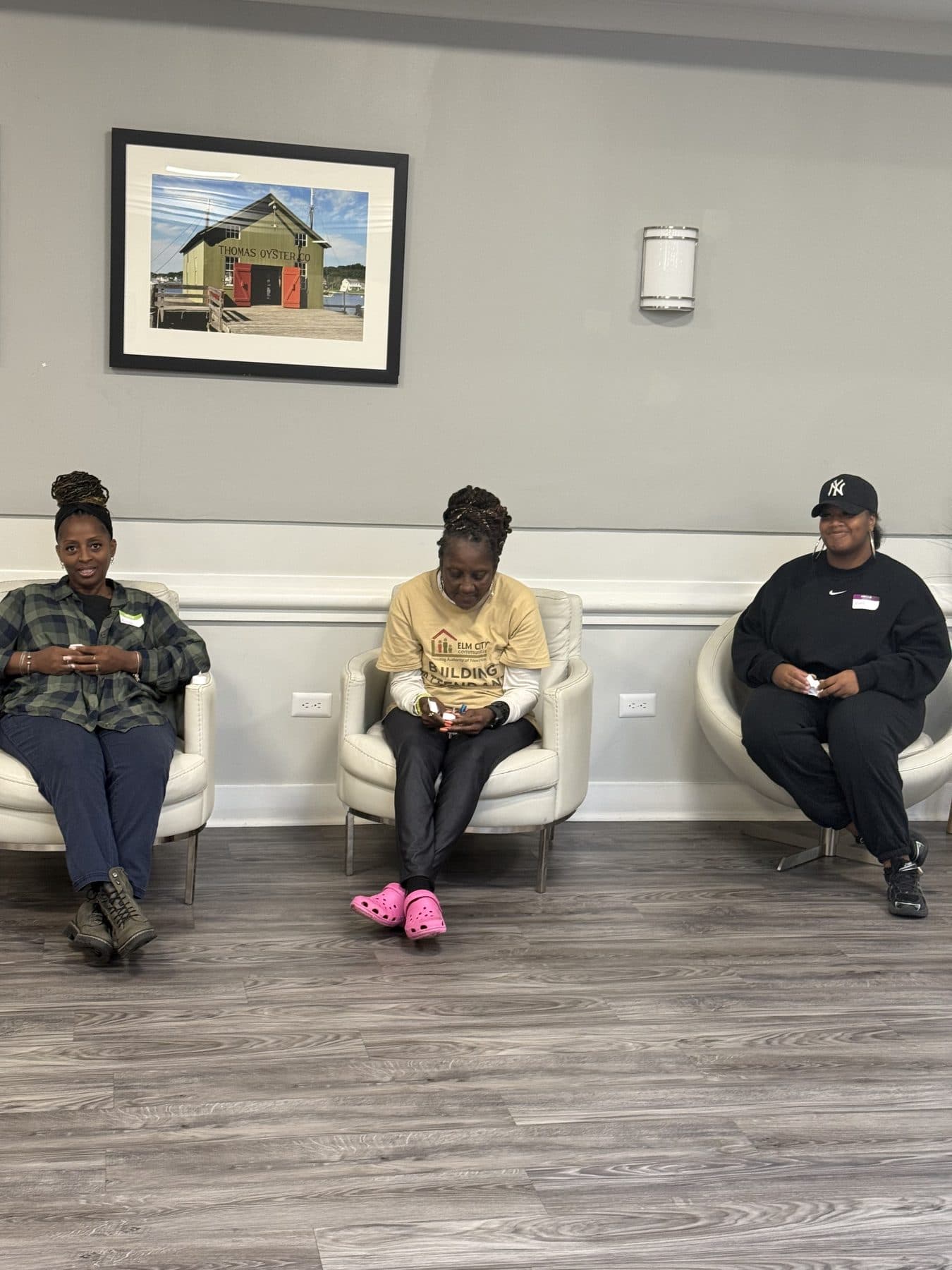 Three people seated together at a community event