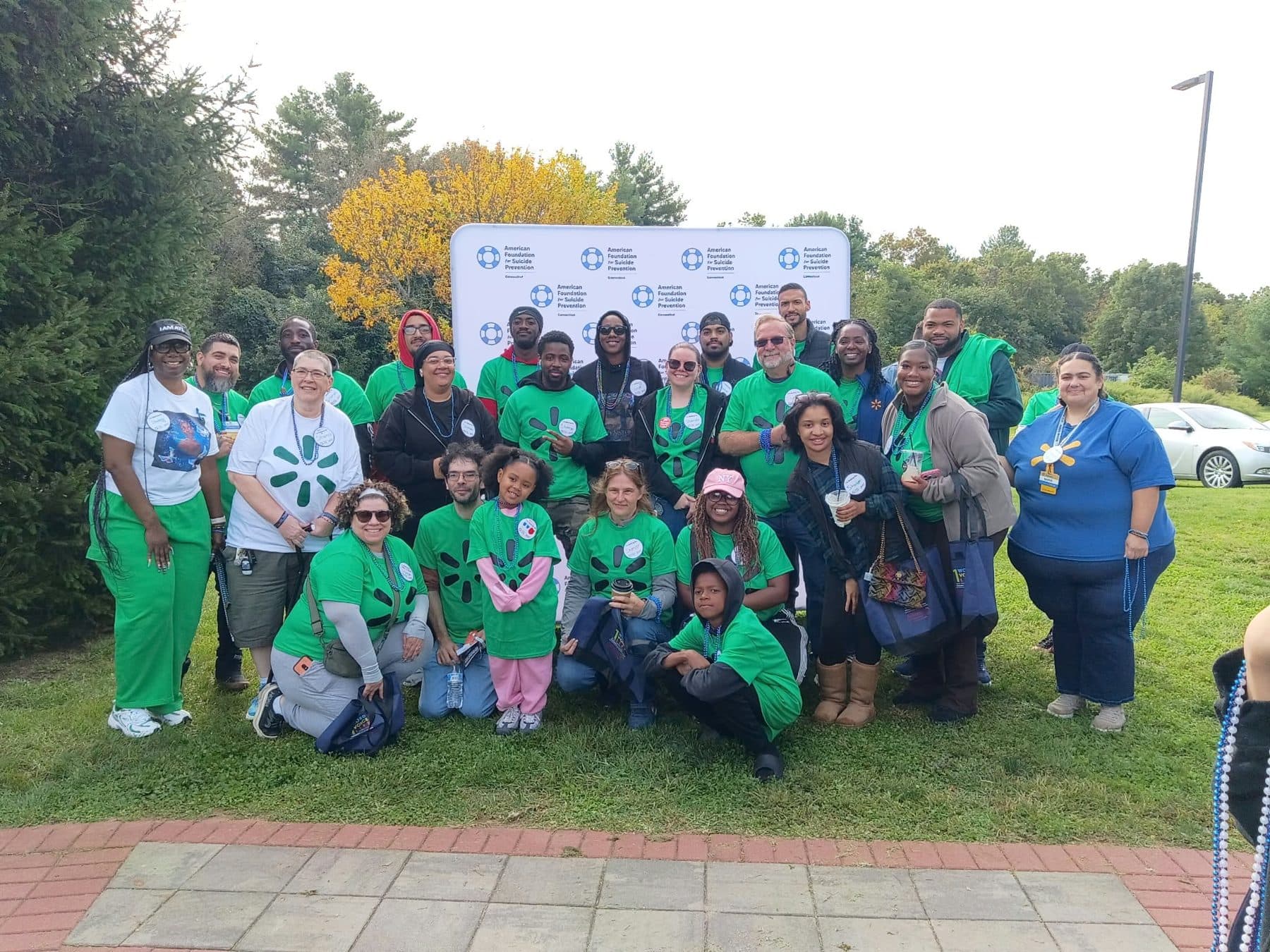 A group in green shirts at a community walk